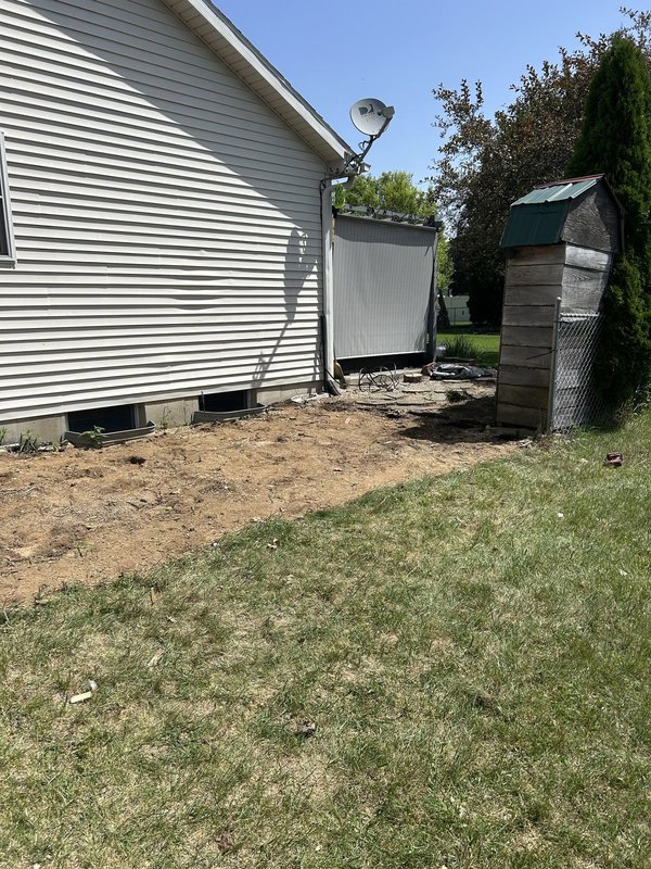 Cluttered backyard deck before removal and the cleared ground after — After